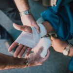 person applying bandage on another person s hand