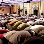 large gathering of people in outdoor prayer