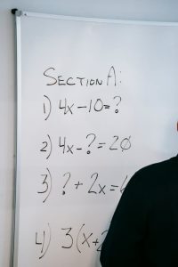 photo of math equations written on whiteboard